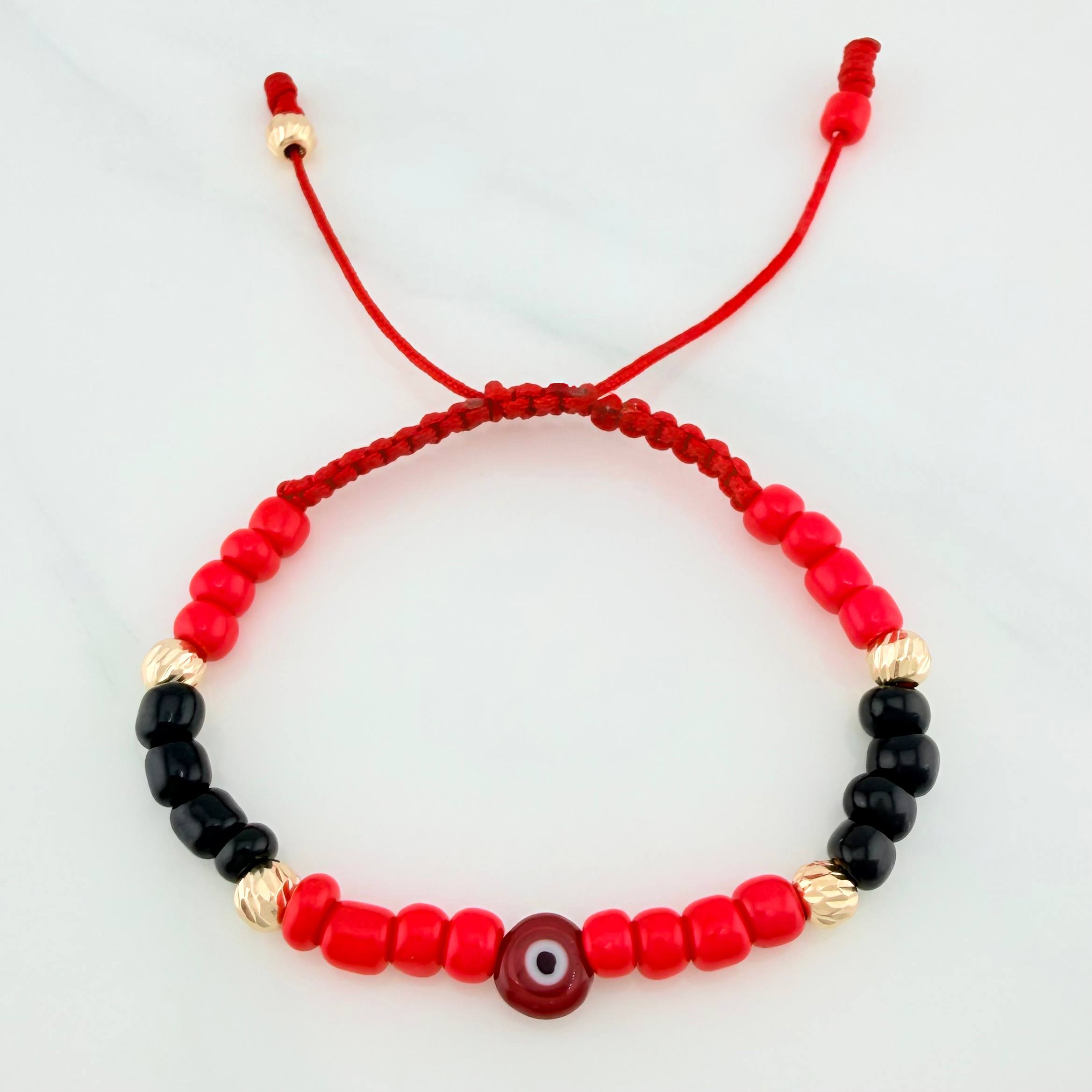 Pulsera tejida roja con mostacillas y ojo turco